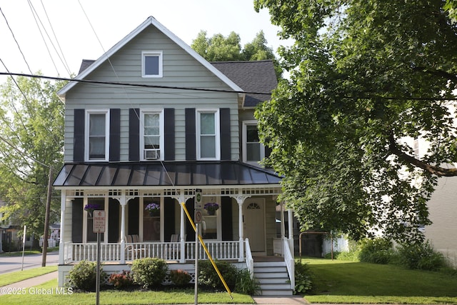 67 Van Dam St, Saratoga Springs, NY 12866 - view of front of house with covered porch, a standing seam roof, a front lawn, a shingled roof, and a metal roof