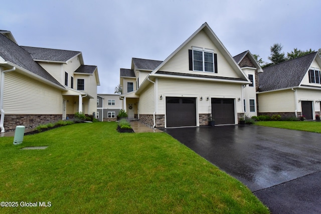 16 Anthony Pl, Ballston, NY 12020 - view of front of house with asphalt driveway, an attached garage, stone siding, and a front yard
