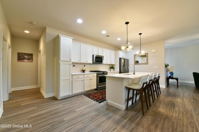16 Anthony Pl, Ballston, NY 12020 - kitchen with high quality appliances, dark wood finished floors, a center island with sink, recessed lighting, and white cabinets