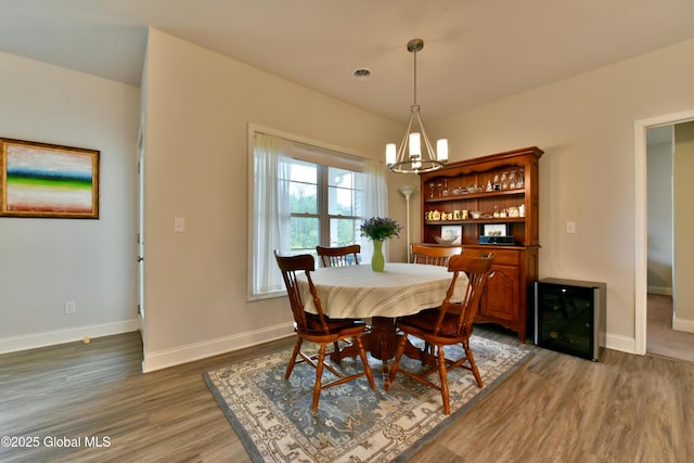 16 Anthony Pl, Ballston, NY 12020 - dining space featuring beverage cooler, a chandelier, and wood finished floors