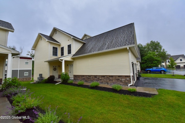 16 Anthony Pl, Ballston, NY 12020 - view of front of house with a front lawn, roof with shingles, and stone siding
