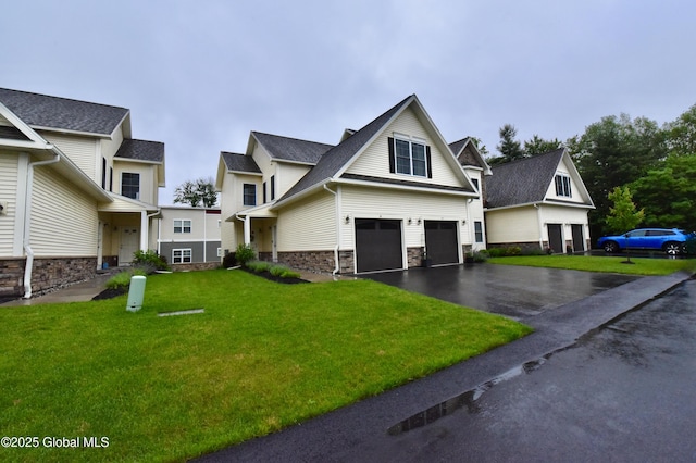 16 Anthony Pl, Ballston, NY 12020 - view of front of property with stone siding, driveway, an attached garage, and a front yard
