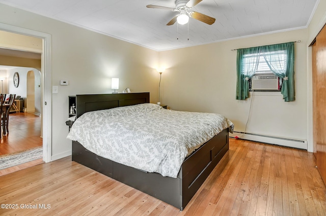 17 Malpass Rd, Guilderland, NY 12203 - bedroom with a baseboard heating unit, crown molding, arched walkways, light wood-style floors, and cooling unit