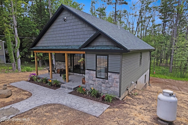 19 Forest Rd, Queensbury, NY 12845 - view of front of home featuring roof with shingles and stone siding