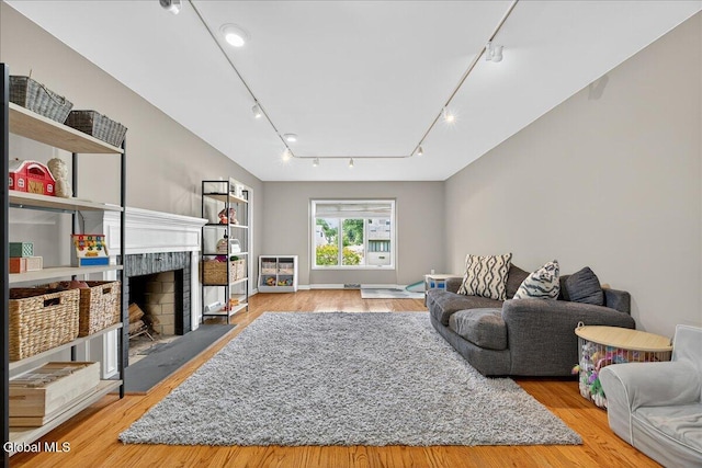 1 Fox Run, Colonie, NY 12110 - living area with rail lighting, wood finished floors, and a fireplace