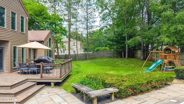1 Fox Run, Colonie, NY 12110 - fenced backyard featuring outdoor dining area, a playground, a deck, and view of wooded area