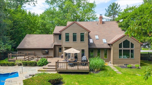 1 Fox Run, Colonie, NY 12110 - rear view of house featuring a wooden deck, a yard, a chimney, and roof with shingles