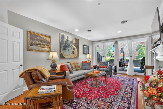 70 Railroad Pl Unit 207, Saratoga Springs, NY 12866 - living area featuring wood finished floors, recessed lighting, and a fireplace