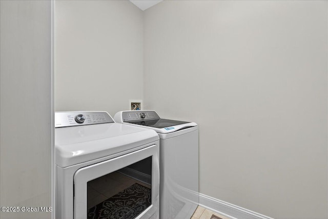 70 Railroad Pl Unit 207, Saratoga Springs, NY 12866 - laundry room with washer and clothes dryer and light tile patterned floors