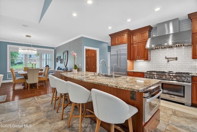 6 Corinne Ct, Saratoga, NY 12866 - kitchen with wall chimney exhaust hood, high quality appliances, ornamental molding, light stone counters, and tasteful backsplash