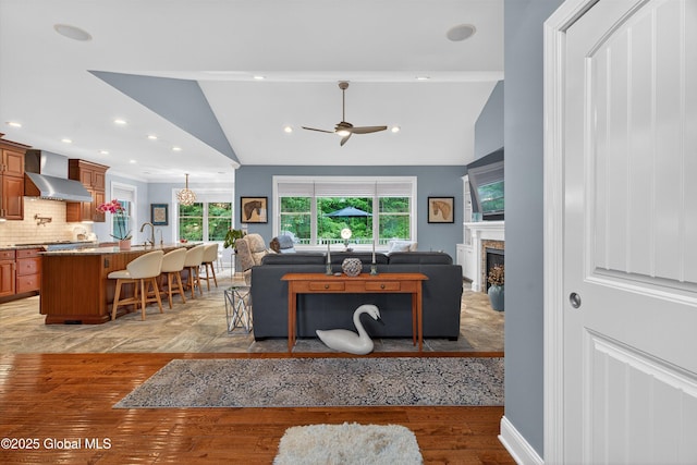 6 Corinne Ct, Saratoga, NY 12866 - living room with ceiling fan, a glass covered fireplace, lofted ceiling, light wood-style flooring, and recessed lighting