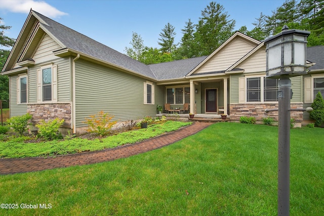 6 Corinne Ct, Saratoga, NY 12866 - view of front of home with stone siding, a front yard, a shingled roof, and a porch