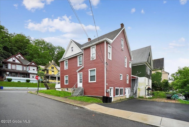 329 E Main St, Amsterdam, NY 12010 - view of side of property featuring a chimney and entry steps