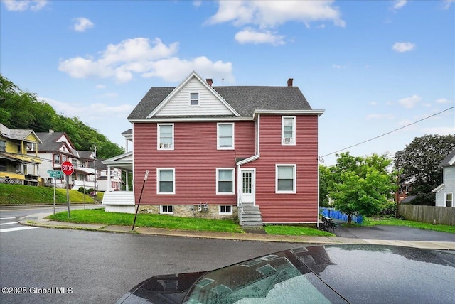 329 E Main St, Amsterdam, NY 12010 - rear view of house featuring entry steps, a chimney, and a shingled roof