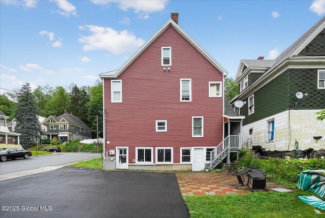 329 E Main St, Amsterdam, NY 12010 - view of home's exterior with a chimney