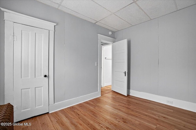 329 E Main St, Amsterdam, NY 12010 - unfurnished bedroom featuring light wood-style floors and a drop ceiling