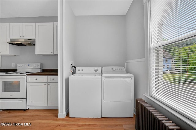 329 E Main St, Amsterdam, NY 12010 - laundry room with radiator, washing machine and dryer, and light wood-style floors