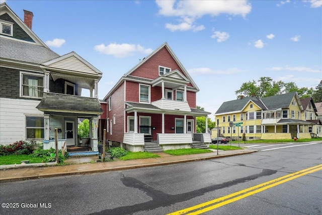 329 E Main St, Amsterdam, NY 12010 - view of property featuring covered porch, a residential view, and a balcony