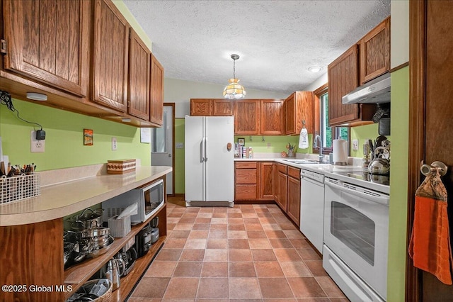 585 Logtown Rd, Glen, NY 12072 - kitchen featuring white appliances, under cabinet range hood, light countertops, brown cabinetry, and a textured ceiling