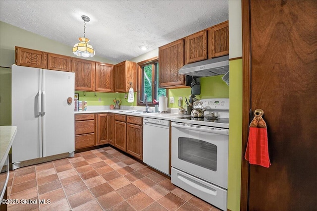 585 Logtown Rd, Glen, NY 12072 - kitchen featuring white appliances, under cabinet range hood, a textured ceiling, light countertops, and hanging light fixtures