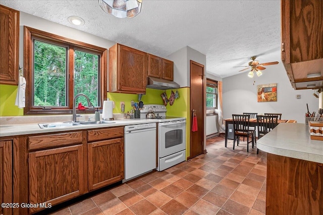 585 Logtown Rd, Glen, NY 12072 - kitchen featuring white appliances, under cabinet range hood, a textured ceiling, a ceiling fan, and brown cabinets
