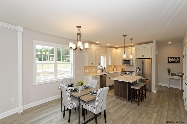 1E Brison St, North Greenbush, NY 12180 - dining area with a chandelier, light wood-style floors, and recessed lighting