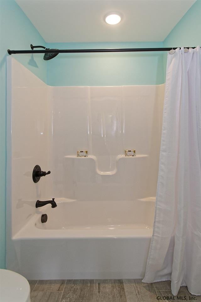 1E Brison St, North Greenbush, NY 12180 - bathroom featuring shower / bath combination with curtain and wood finished floors