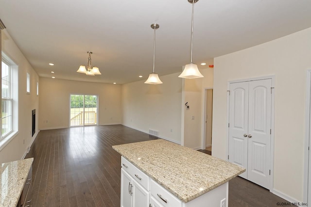 1E Brison St, North Greenbush, NY 12180 - kitchen featuring hanging light fixtures, white cabinets, a center island, dark wood-style flooring, and light stone counters