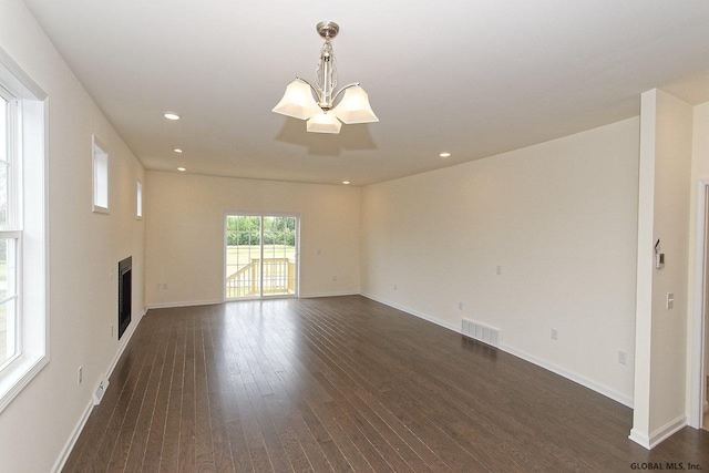 1E Brison St, North Greenbush, NY 12180 - unfurnished living room with dark wood-type flooring, a chandelier, a fireplace, and recessed lighting