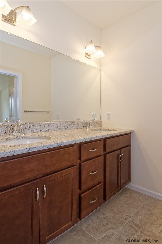 1E Brison St, North Greenbush, NY 12180 - bathroom featuring double vanity and baseboards