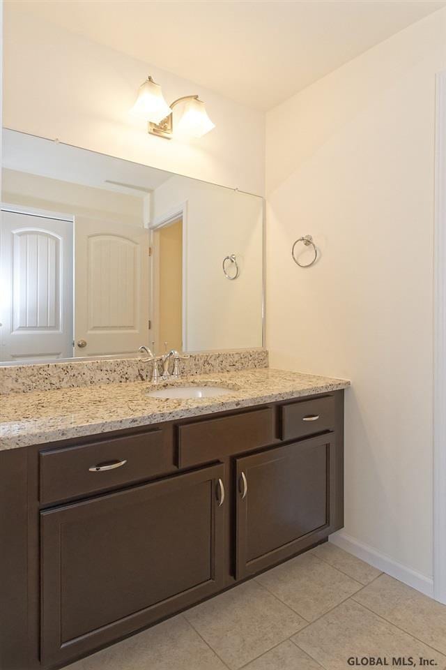 1E Brison St, North Greenbush, NY 12180 - bathroom with vanity and tile patterned flooring