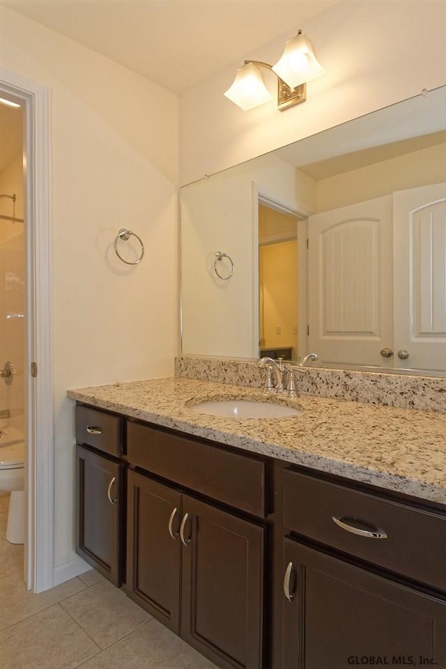1E Brison St, North Greenbush, NY 12180 - bathroom featuring tile patterned floors, vanity, and a shower