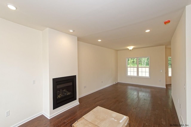 1E Brison St, North Greenbush, NY 12180 - unfurnished living room with dark wood finished floors, a glass covered fireplace, and recessed lighting