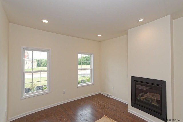 1E Brison St, North Greenbush, NY 12180 - unfurnished living room with dark wood-type flooring, recessed lighting, and a glass covered fireplace