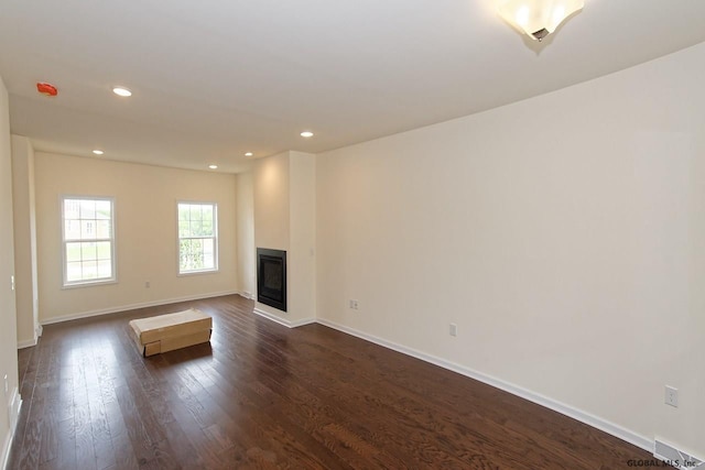 1E Brison St, North Greenbush, NY 12180 - unfurnished living room with dark wood-type flooring, a glass covered fireplace, and recessed lighting