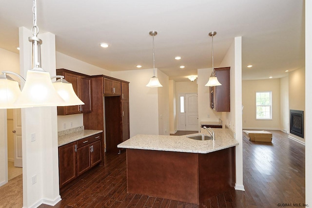 1E Brison St, North Greenbush, NY 12180 - kitchen featuring dark wood-style flooring, light stone counters, a peninsula, decorative light fixtures, and recessed lighting