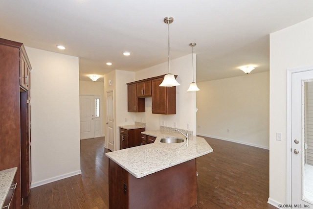 1E Brison St, North Greenbush, NY 12180 - kitchen with dark wood-style floors, light stone counters, recessed lighting, and pendant lighting