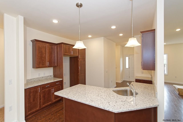 1E Brison St, North Greenbush, NY 12180 - kitchen with dark wood-style floors, a peninsula, recessed lighting, light stone countertops, and pendant lighting