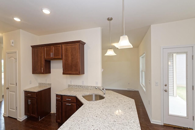 1E Brison St, North Greenbush, NY 12180 - kitchen with light stone countertops, dark wood-style flooring, pendant lighting, recessed lighting, and dark brown cabinetry