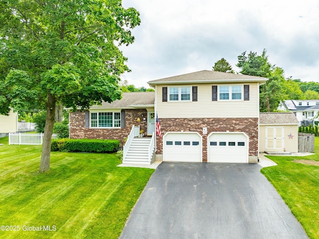34 Aspen Rd, Colonie, NY 12110 - tri-level home featuring asphalt driveway, an attached garage, and brick siding