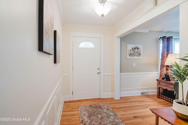34 Aspen Rd, Colonie, NY 12110 - foyer with a decorative wall, light wood-style floors, wainscoting, and crown molding