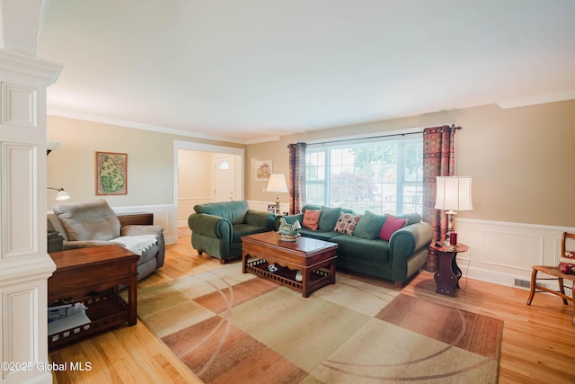 34 Aspen Rd, Colonie, NY 12110 - living area with wood finished floors, a wainscoted wall, crown molding, and a decorative wall