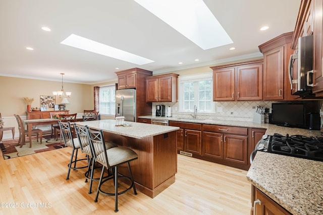 34 Aspen Rd, Colonie, NY 12110 - kitchen featuring stainless steel appliances, a skylight, ornamental molding, healthy amount of natural light, and recessed lighting