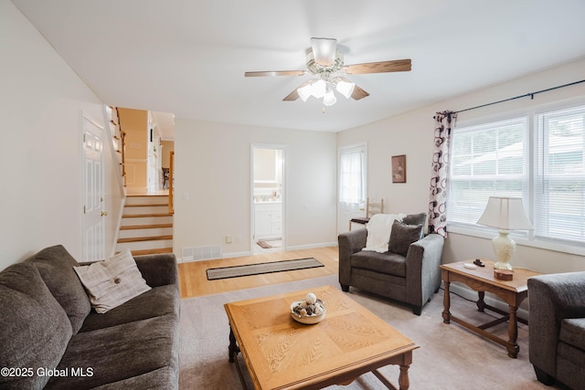 34 Aspen Rd, Colonie, NY 12110 - living area with stairway, a ceiling fan, and healthy amount of natural light