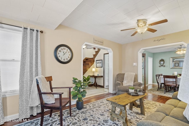 2730 Denver Ave, Rotterdam, NY 12306 - living room with arched walkways, a ceiling fan, stairway, and wood finished floors