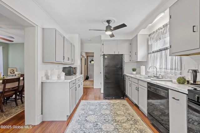 2730 Denver Ave, Rotterdam, NY 12306 - kitchen with black appliances, ceiling fan, light wood-type flooring, and light countertops