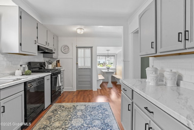 2730 Denver Ave, Rotterdam, NY 12306 - kitchen featuring black appliances, under cabinet range hood, tasteful backsplash, and wood finished floors