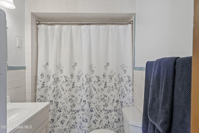 2730 Denver Ave, Rotterdam, NY 12306 - full bathroom with vanity, tile walls, and a shower with curtain