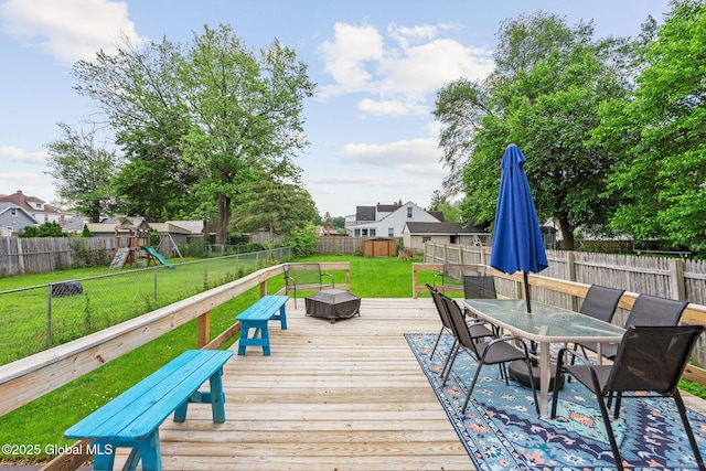 2730 Denver Ave, Rotterdam, NY 12306 - wooden terrace featuring outdoor dining area, a fenced backyard, and a playground