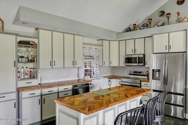 3140 State Route 5s, Danube, NY 13339 - kitchen featuring appliances with stainless steel finishes, butcher block counters, decorative backsplash, and lofted ceiling
